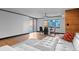 Bright living room with wood floors, city views, and a modern white leather couch at 1551 Larimer St # 1106, Denver, CO 80202