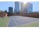 Outdoor tennis court surrounded by city buildings and bright sunny day at 1551 Larimer St # 1106, Denver, CO 80202