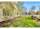 A well-maintained backyard features a lush lawn, mature trees, and a charming white picket fence at 24784 E Arkansas Pl, Aurora, CO 80018
