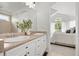 Bright bathroom with double sink vanity, and an open view to a bedroom with natural light at 24784 E Arkansas Pl, Aurora, CO 80018