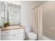 Bathroom featuring tub with shower, white toilet, and a vanity with drawers for storage at 24784 E Arkansas Pl, Aurora, CO 80018