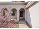 Inviting home entryway featuring a classic dark door framed by elegant arched columns and neutral stone accents at 24784 E Arkansas Pl, Aurora, CO 80018