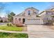 Charming stucco two-story home with a well-manicured lawn and a two-car garage in a suburban neighborhood at 24784 E Arkansas Pl, Aurora, CO 80018