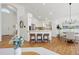 Open kitchen design with hardwood floors, island seating, and stainless steel appliances at 24784 E Arkansas Pl, Aurora, CO 80018