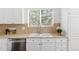 Close-up of the kitchen sink with stainless steel fixtures and ample countertop space at 24784 E Arkansas Pl, Aurora, CO 80018