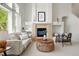 Bright living room features a fireplace, light-colored sofa, and stylish decor at 24784 E Arkansas Pl, Aurora, CO 80018