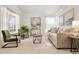 Bright living room with neutral decor, large windows, and stylish furnishings creating a cozy atmosphere at 24784 E Arkansas Pl, Aurora, CO 80018