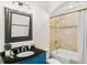 Bright bathroom featuring a blue vanity, granite countertop and tiled shower at 2330 N Emerson St, Denver, CO 80205