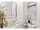 Bright bathroom with a modern vanity, granite counters, and a decorative mirror at 2330 N Emerson St, Denver, CO 80205
