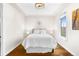 Cozy bedroom with a tray ceiling, hardwood floors, and natural light at 2330 N Emerson St, Denver, CO 80205