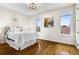 Bright bedroom with hardwood floors, tray ceiling, and large windows with city views at 2330 N Emerson St, Denver, CO 80205