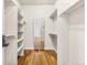 Walk-in closet with custom shelving and hardwood floors provides ample storage at 2330 N Emerson St, Denver, CO 80205