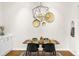 Dining area with modern light fixture, seating for four, and hardwood floors at 2330 N Emerson St, Denver, CO 80205