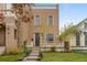 Beautiful brick home with a well-manicured lawn, front porch and budding trees at 2330 N Emerson St, Denver, CO 80205
