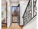 Entry foyer with hardwood floors, metal staircase, and a view of blossoming trees at 2330 N Emerson St, Denver, CO 80205