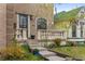 Charming brick house featuring inviting front porch and budding trees at 2330 N Emerson St, Denver, CO 80205