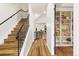 Hallway featuring hardwood floors, metal staircase, and a built-in bookshelf at 2330 N Emerson St, Denver, CO 80205