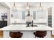 Contemporary kitchen featuring an island with seating, sleek lighting, and white cabinets at 2330 N Emerson St, Denver, CO 80205