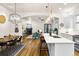 Open concept kitchen with island seating and seamless flow to living and dining at 2330 N Emerson St, Denver, CO 80205