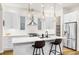 Well-lit kitchen showcasing quartz countertops, modern pendant lights, and white cabinetry at 2330 N Emerson St, Denver, CO 80205