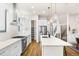 Bright kitchen with stainless steel fridge and large quartz island at 2330 N Emerson St, Denver, CO 80205