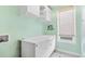 This laundry room features overhead cabinets and a white folding table at 2330 N Emerson St, Denver, CO 80205