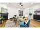 Living room with hardwood floors, fireplace, ceiling fan and large windows for lots of natural light at 2330 N Emerson St, Denver, CO 80205