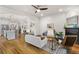 Open concept living room features hardwood floors, a fireplace, and an open floorplan to the kitchen and dining areas at 2330 N Emerson St, Denver, CO 80205