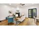 Bright living room features hardwood floors, fireplace, contemporary decor, and a door to the outside at 2330 N Emerson St, Denver, CO 80205