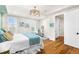 Bedroom with a ceiling fan, hardwood floors, and large windows offering lots of natural light at 2330 N Emerson St, Denver, CO 80205