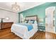 Bright main bedroom with hardwood floors that leads to the ensuite bathroom at 2330 N Emerson St, Denver, CO 80205