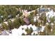 Beautiful aerial view of the home nestled in a heavily wooded lot with snow on the ground at 838 Lakeshore Dr, Boulder, CO 80302