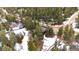 Beautiful aerial view of the home nestled in a heavily wooded lot with snow on the ground at 838 Lakeshore Dr, Boulder, CO 80302