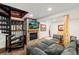 Basement featuring a stone fireplace with a television and a spiral staircase at 838 Lakeshore Dr, Boulder, CO 80302