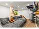 Relaxing basement with a comfortable gray couch and a unique spiral staircase at 838 Lakeshore Dr, Boulder, CO 80302