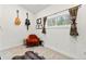 Cozy bedroom with reading chair, decorative rugs, and views to the trees outside at 838 Lakeshore Dr, Boulder, CO 80302