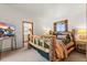 Rustic bedroom featuring a unique log bed frame and view to an ensuite bathroom at 838 Lakeshore Dr, Boulder, CO 80302