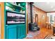 Living area featuring brick fireplace, custom shelving, and views to adjacent dining area at 838 Lakeshore Dr, Boulder, CO 80302