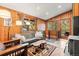 Comfortable living room with wood paneled walls, natural lighting, and rustic wood coffee table at 838 Lakeshore Dr, Boulder, CO 80302