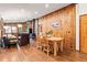 Open-concept living area with wooden walls and floors, a fireplace, and comfortable seating at 838 Lakeshore Dr, Boulder, CO 80302