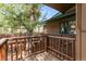 Wooden porch featuring railings and stairs, set amongst mature trees and nature at 838 Lakeshore Dr, Boulder, CO 80302