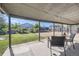 Covered backyard patio with outdoor seating, offering a serene view of the spacious fenced backyard and garden at 5222 Xanadu St, Denver, CO 80239