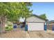 Charming home featuring attached garage, neutral siding, and blue accents at 5222 Xanadu St, Denver, CO 80239