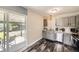Modern kitchen with stainless steel appliances, gray cabinets, and sliding glass doors leading to the outdoor patio at 5222 Xanadu St, Denver, CO 80239