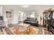 Inviting living room featuring stylish furniture, a modern coffee table, and hardwood floors with an elegant rug at 5222 Xanadu St, Denver, CO 80239