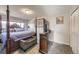 Comfortable main bedroom with a four-poster bed, soft lighting, and closet, creating a relaxing retreat at 5222 Xanadu St, Denver, CO 80239