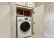 This bathroom features a compact washer/dryer in the cabinet at 7255 E Quincy Ave # 404, Denver, CO 80237
