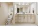 Bright bathroom featuring double vanity, classic hardware, and a clean aesthetic at 7255 E Quincy Ave # 404, Denver, CO 80237