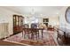 Formal dining room with chandelier, hardwood floors, and elegant furnishings at 7255 E Quincy Ave # 404, Denver, CO 80237