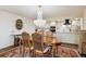 Well-lit dining room with a chandelier and wood table next to the kitchen at 7255 E Quincy Ave # 404, Denver, CO 80237